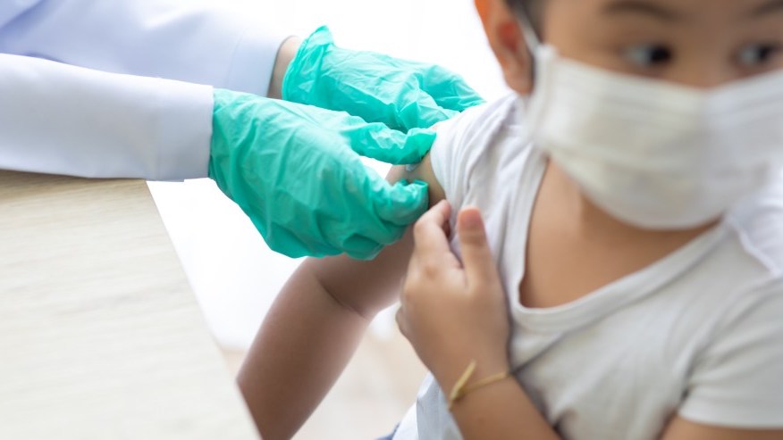 Hepatitis B Vaccine Gloved Adult Hands Preparing a Child Patient for Shot in the Arm