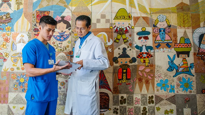 A trainee and a mentor conferring near the UCLA Mattel Children's Hospital