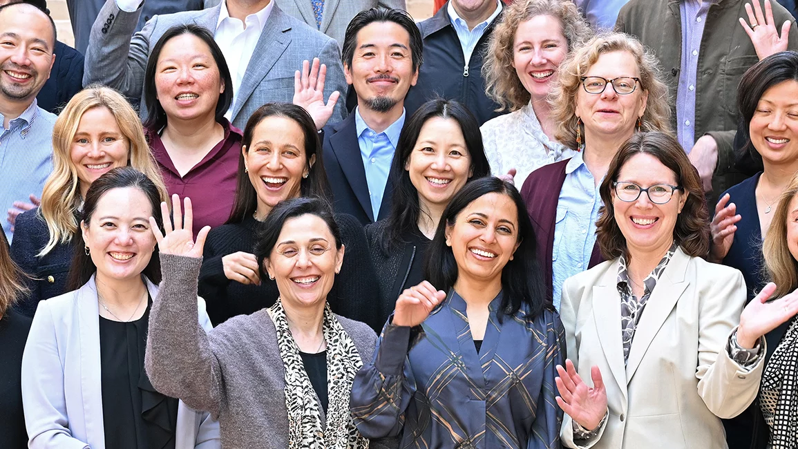 DGSOM faculty group smiling and waving at the Anderson Management Program