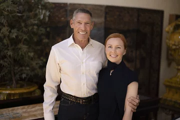Gary Michelson, left, and Aya Michelson stand with arms around each other