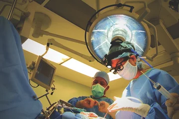 A team of surgeons completing a procedure in the operating room