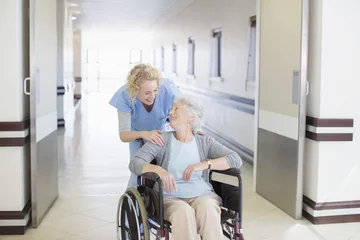 Occupational or Physical Therapist Assisting Elderly Woman in Wheelchair
