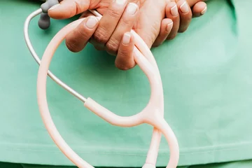 hands holding a stethoscope