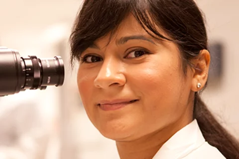 Female researcher with microscope