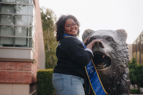 Becoming a doctor: Ky'Tavia Stafford-Carreker with UCLA Bruin bear 
