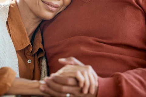Black-African American couple holding hands - image for FTD Caregiver Support Group