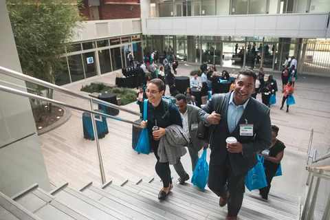 EDI conference break in Geffen Hall, participants walking up the stairs of the courtyard