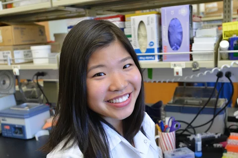 A research trainee smiles at the bench.