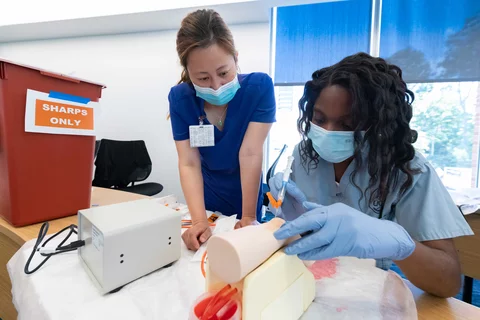 Study Skills to Succeed in Medical School - Two women practicing hands on clinical skills in a simulated environment