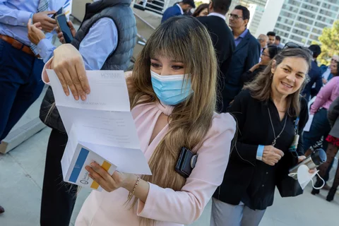 4th year medical school student opens her match results on Match Day 2022 wearing a mask