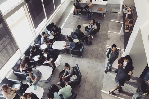 A view of the student lounge area, filled with med students, overlooking the Geffen Hall courtyard