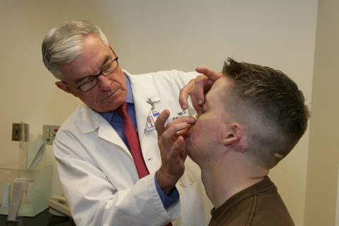 Dr. Timothy Miller treats Cpl. Aaron P. Mankin. 