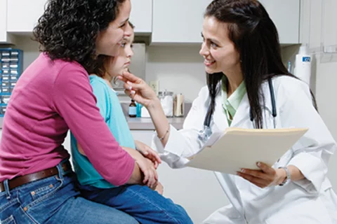 A Day in the Life of a Pediatrician Doctor Talking to Young Patient 
