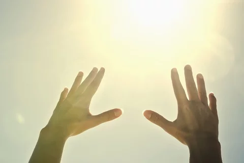 Hands reaching in the sky