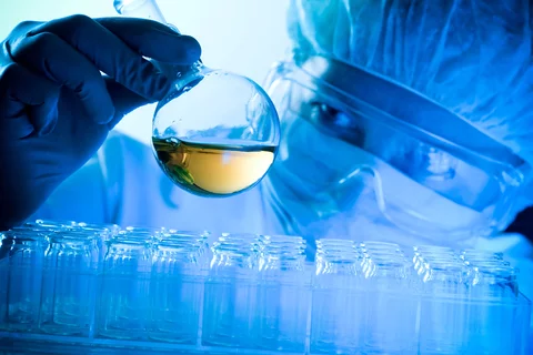 Scientist look at tube filled with liquid