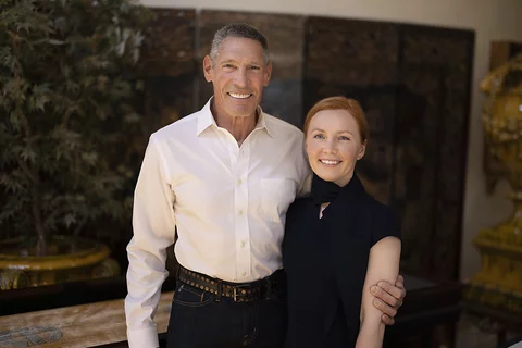 Gary Michelson, left, and Aya Michelson stand with arms around each other