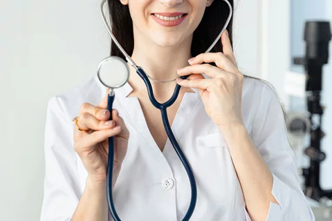 Female doctor holds up stethoscope