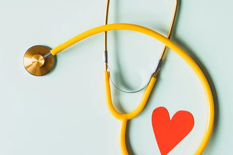 yellow stethoscope with a heart in the loop