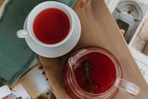 two mugs of tea sitting on a wooden board