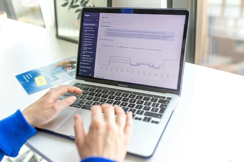 close up of laptop screen and typing hands