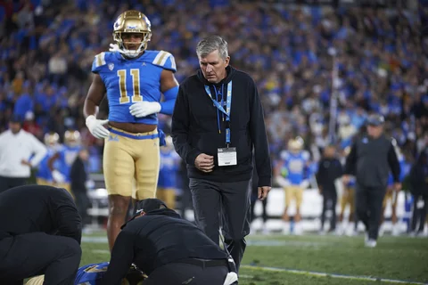 Sports medicine physician helping a UCLA football player