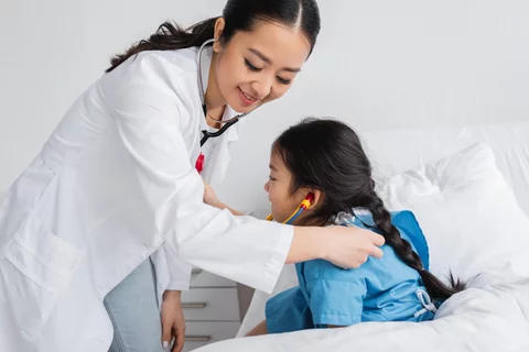 Doctor examines pediatric patient with stethoscope
