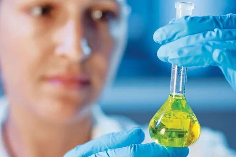 Female scientist holding beaker