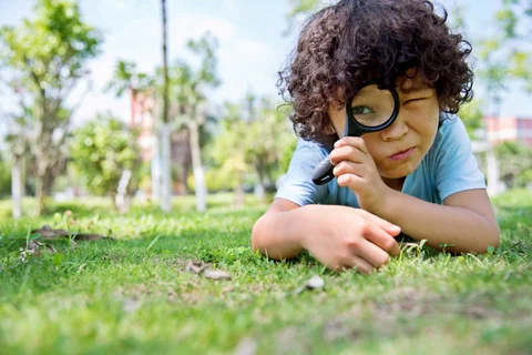 What Is Tourette Syndrome Child on Grass Looking Through Microscope