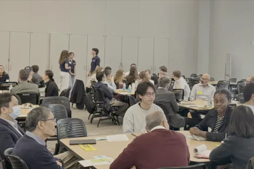 Researchers engaging in roundtable discussions in Geffen Hall