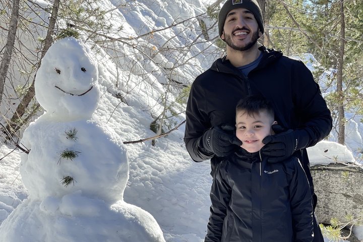 Becoming a Doctor: Gustavo Castellanos and his son build a snowman