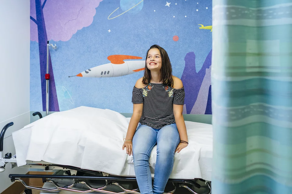 Pediatric patient sitting in an examination room