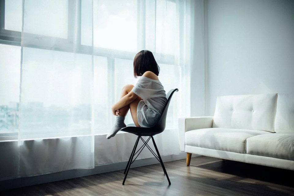 A person sitting in a protective position