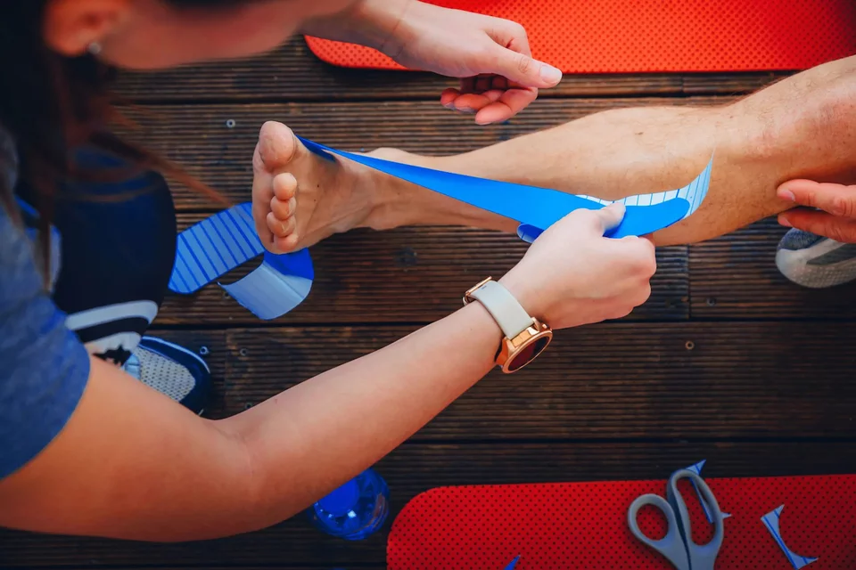 Sports Medicine Careers Article Physician Taping Athlete Ankle