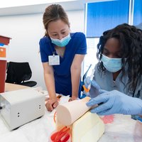 Study Skills to Succeed in Medical School - Two women practicing hands on clinical skills in a simulated environment