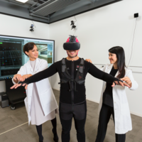 Investigators researching virtual reality technology with a human subject