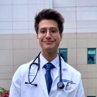 Medical student Eric Smith, pictured wearing his white coat, shares his story of becoming a doctor
