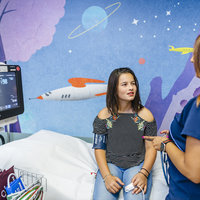 Pediatric cardiologist checks vital signs of her pediatric cardiology patient 
