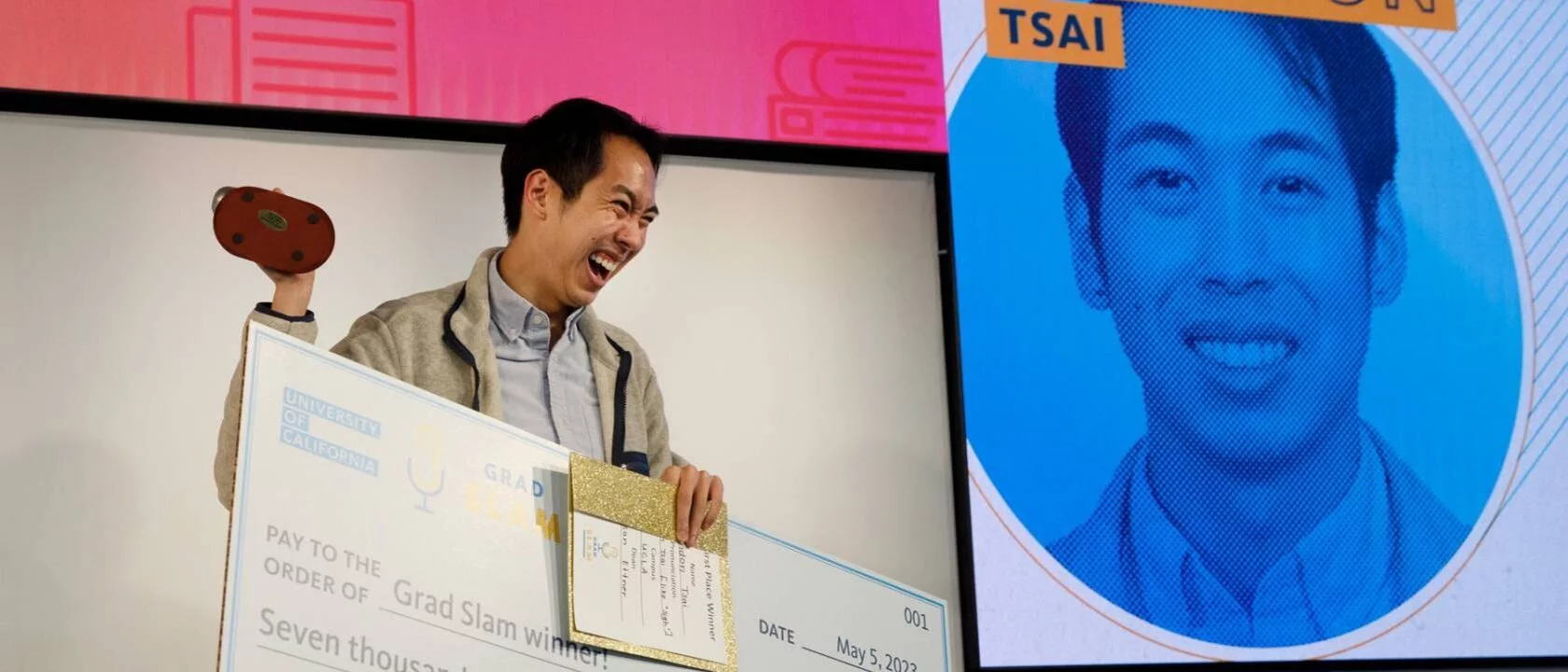 Brandon Tsai holding winning UC Grad Slam check - Human Genetics