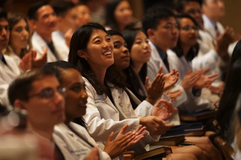 Audience applauding at the White Coat Ceremony