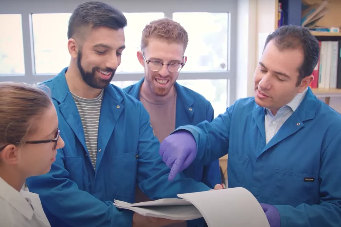 A scientific team in medical school reviewing documents together