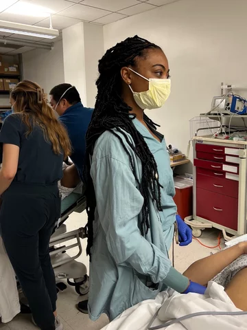 Medical student Shami-Iyabo Mitchell, pictured here in scrubs, shares her story of becoming a doctor.