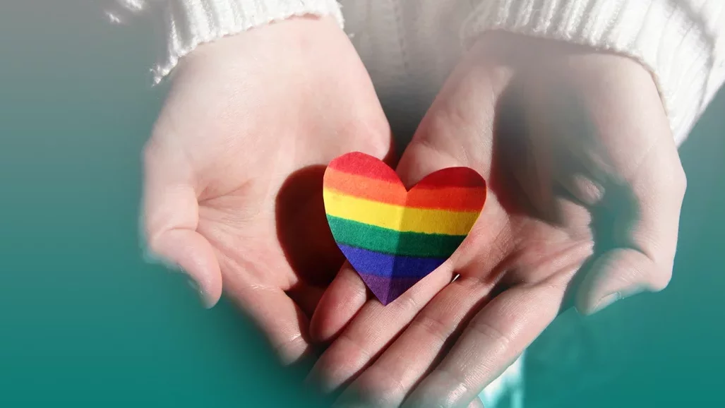 Rainbow heart in hands