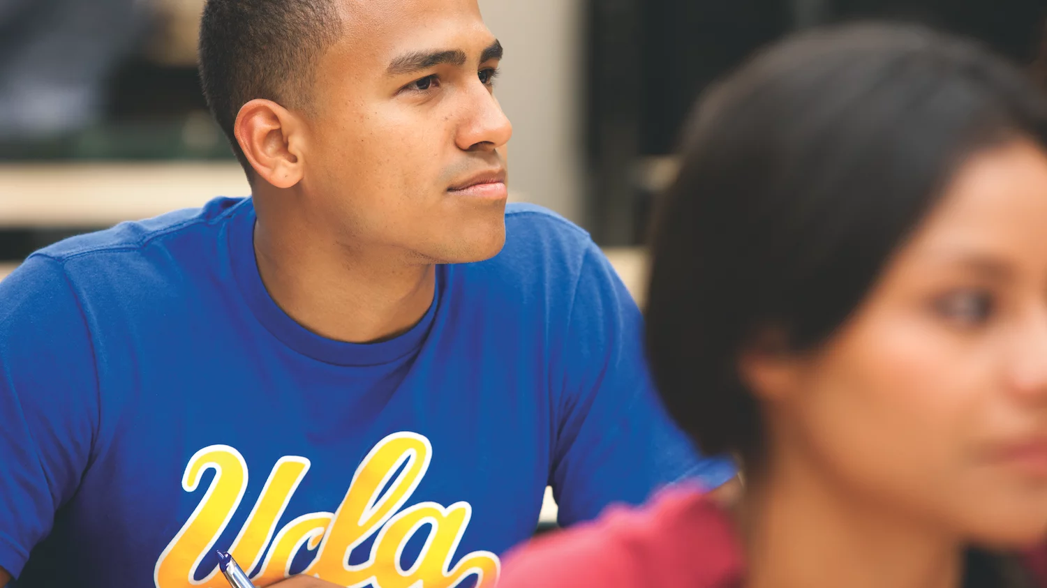 A black male medical student in medical school wearing a blue UCLA shirt