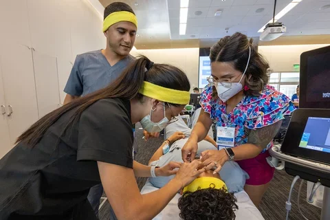 Four medical school students working through a live simulation problem together