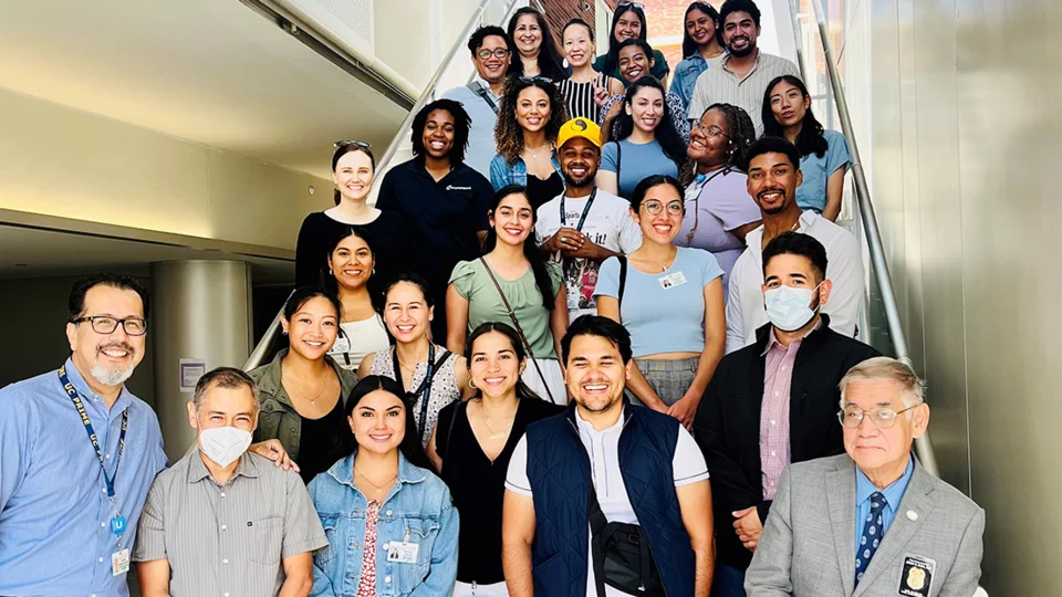 PRIME students and faculty advisors on the stairs in Geffen Hall