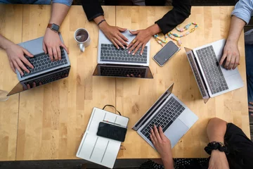 People working on laptops at a table