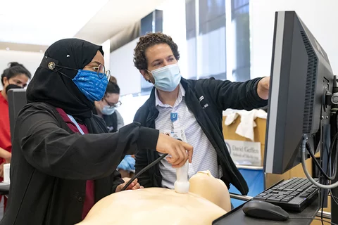 Medical school faculty member mentoring students in a career in medicine