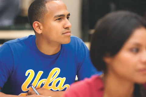 A black male medical student in medical school wearing a blue UCLA shirt