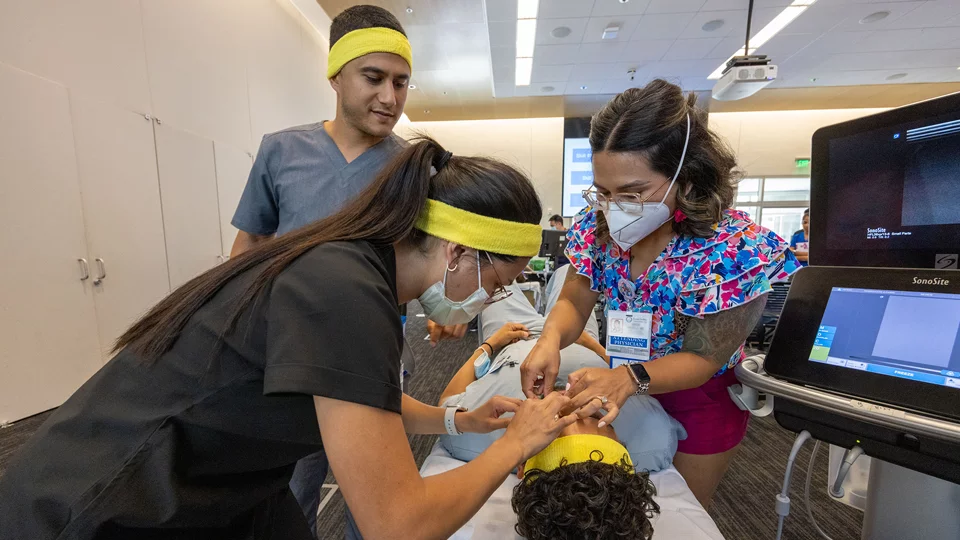Four medical school students working through a live simulation problem together